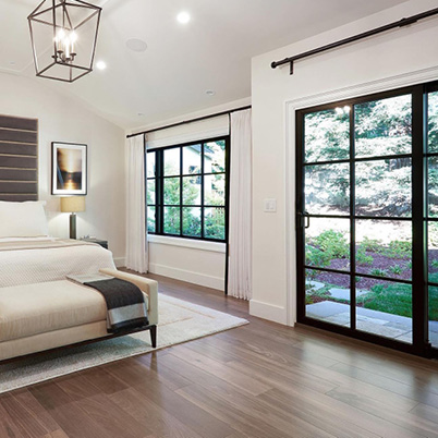 Bedroom featuring black windows and doors with grilles, contemporary look