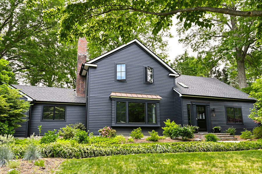 A modern Cape Cod with a black exterior and matching windows and doors.