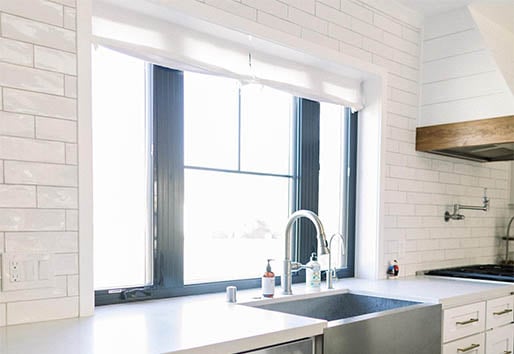 Modern White Kitchen with Window over sink oranjebuilders