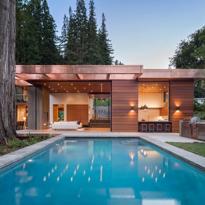 Modern exterior of house with an indoor/outdoor living space with an outdoor pool.