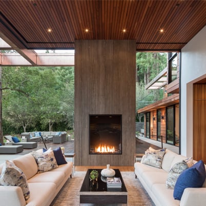 Modern indoor/outdoor cozy living room with a fireplace.