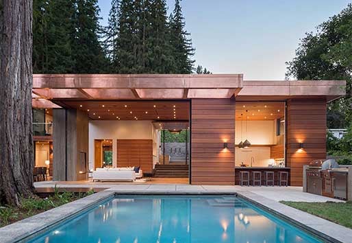 modern wood exterior home poolside with andersen windows and doors