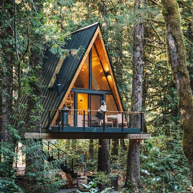 a frame tree house surrounded by trees
