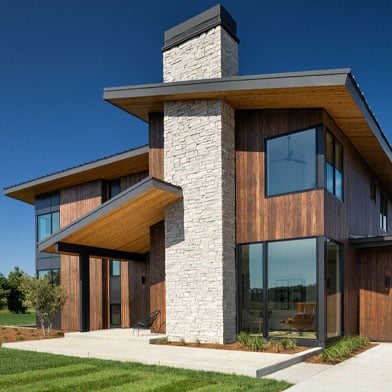 modern home with cedar siding and black frame andersen windows