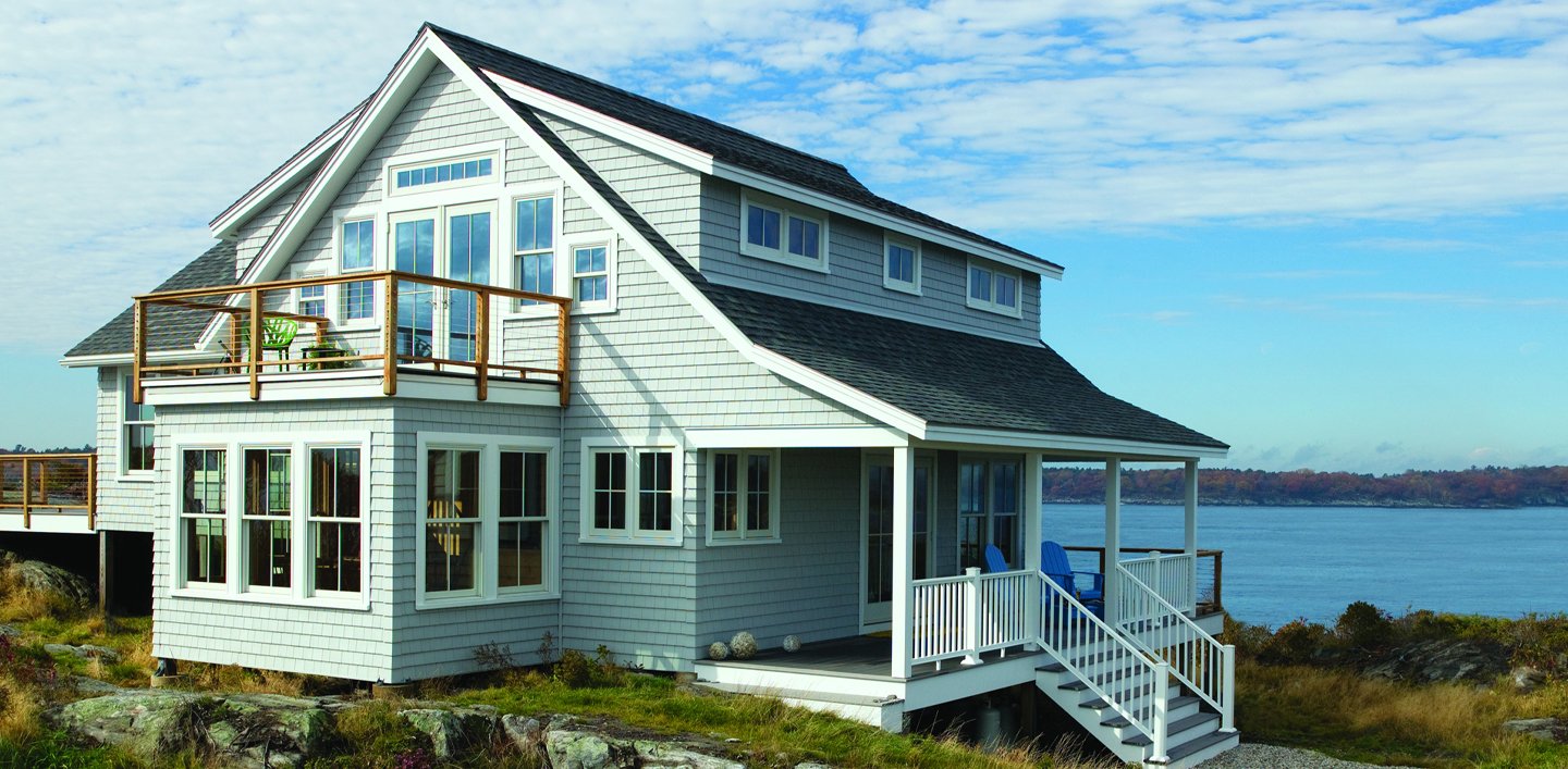 cape cod style home next to water