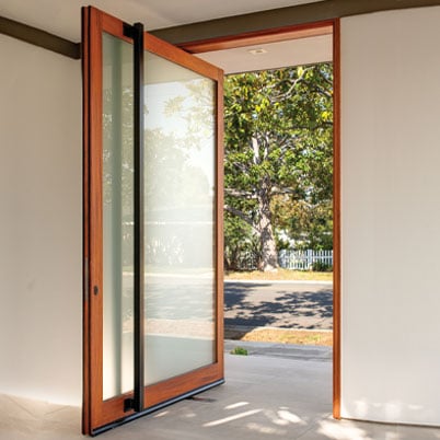 pivot door opened to outside with wood trim