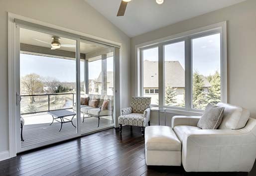 Interior of white living space with patio view through an Andersen 100 series gliding door