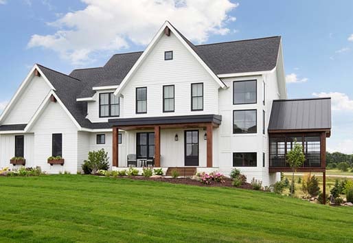Exterior of white home with black Andersen 100 series single-hung windows